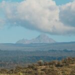 Mount Kenya's peaks rising above the forested foothills, Kenya
